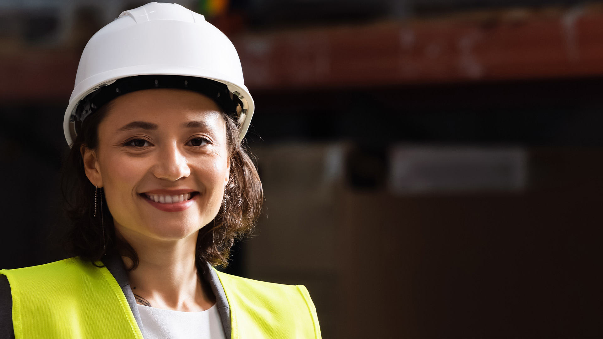 A smiling miner wearing a hard hat